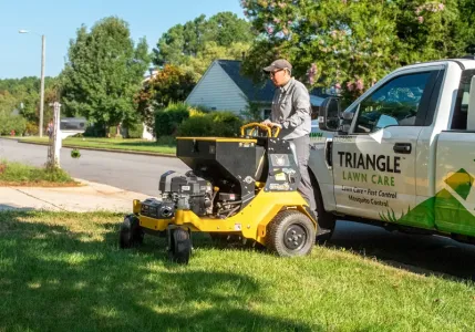 technician aerating lawn