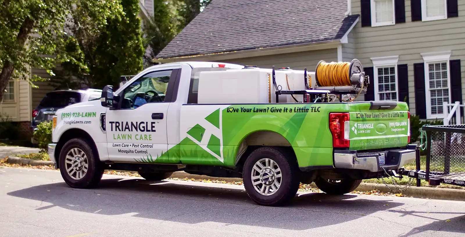 Triangle Lawn Care truck in front of clients home