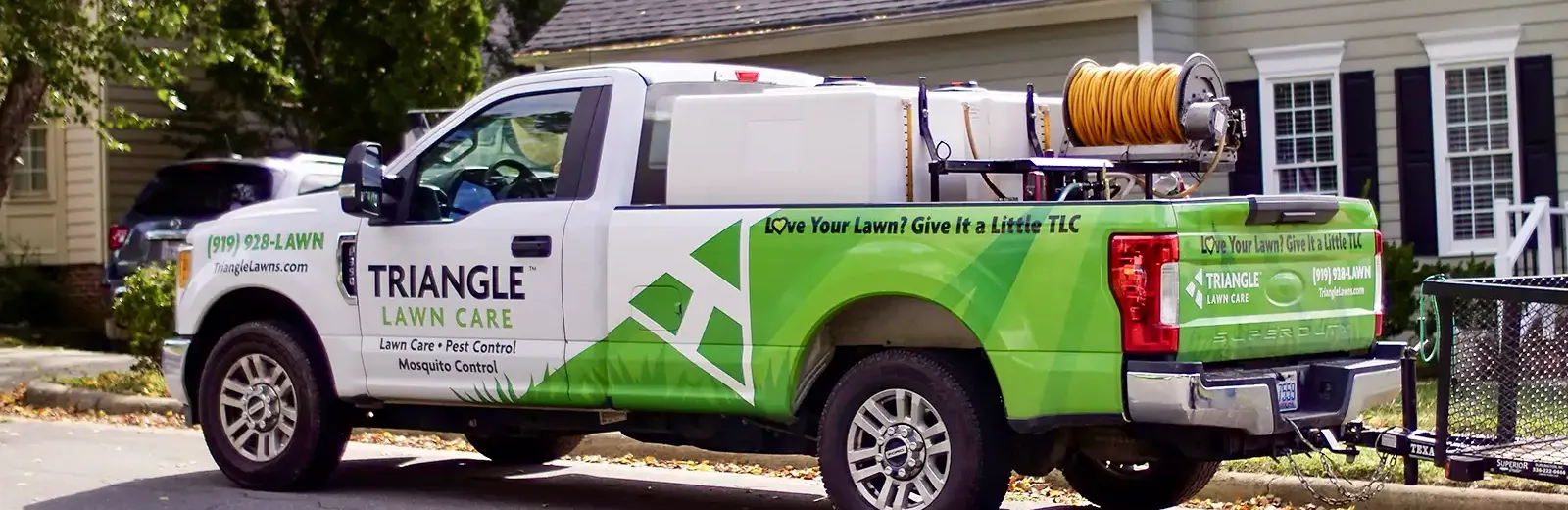 Triangle Lawn Care truck in front of clients home