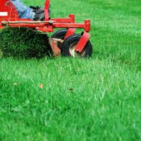 red lawn mower mowing the grass
